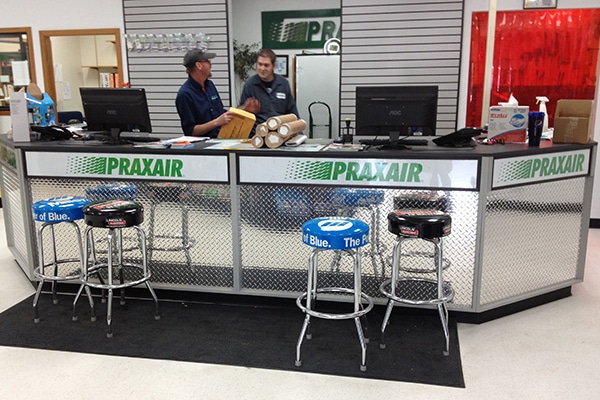 DisplayMax team designed and installed Praxair front sales counter showcasing custom retail fixture design.
