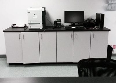 DisplayMax team–installed counter with storage shelves showcasing custom retail fixture design.