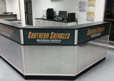 DisplayMax team installed Southern Shingles front sales counter showcasing custom retail fixture design.