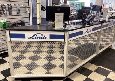 DisplayMax team installed Linde front sales counter showcasing custom retail fixture design.
