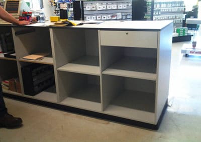 DisplayMax team installed Praxair front sales counter showcasing custom retail fixture design.