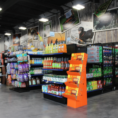 Retail store aisle with stocked shelving and a custom branded endcap display