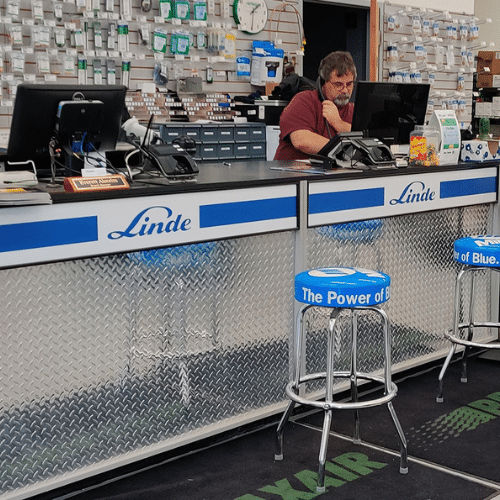 Linde-branded retail checkout counter with custom graphics