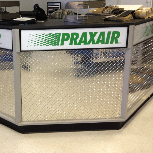 Custom Praxair-branded service counter graphics at a welding gas retail center