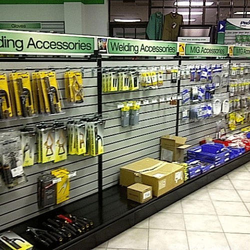 Welding accessories aisle with custom category signage and slatwall product displays